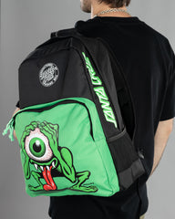 Person wearing a green and black backpack with a cartoon character design on a gray background