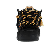 Black and gold sneaker with braided design on a white background