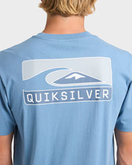 Blue Quiksilver t-shirt worn by a person on a plain background