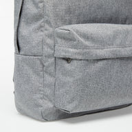 Close-up of a gray backpack corner on a white background