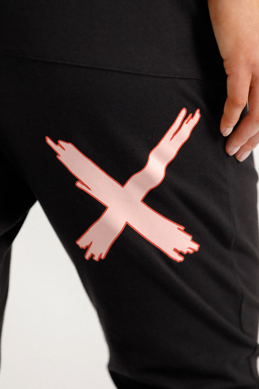 Lady wearing Home-Lee 3/4 Apartment Pants in Black with Blossom Berry X on a white background