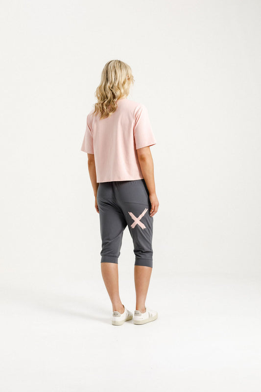 Woman wearing Home-Lee 3/4 Apartment Pants in Graphite and Pink X with White Background