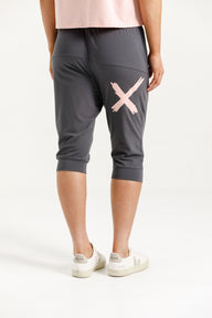 Woman wearing Home-Lee 3/4 Apartment Pants in Graphite and Pink X with White Background