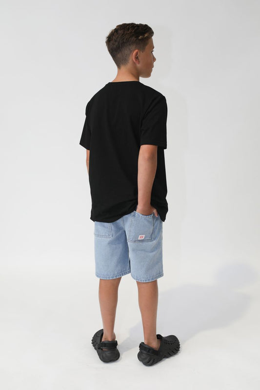 Person wearing a black t-shirt and light blue shorts on a white background