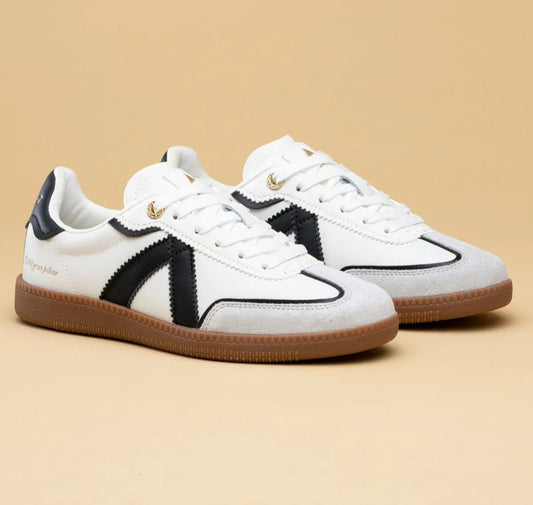 White sneakers with black accents on a beige background