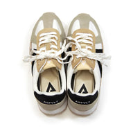 Pair of beige and white sneakers with black accents on a white background