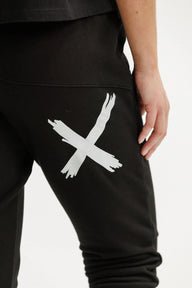 Black pants with a white abstract design on a neutral background
