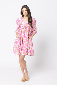 Woman wearing a pink floral dress on a white background