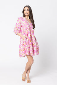 Woman wearing a pink floral dress on a white background