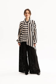Woman wearing a black and white striped shirt on a white background
