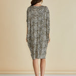 Black and white patterned dress on a beige background