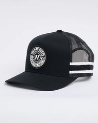 Black trucker cap with white mesh back and logo on a light gray background