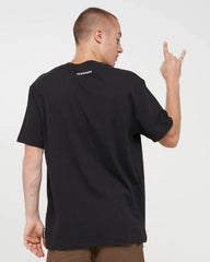 A man wearing a black short-sleeve t-shirt, shown from the back and side. The shirt has a small white graphic printed on the inside of the neck.