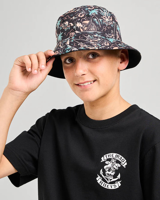 Person wearing a black t-shirt with a graphic design and a patterned bucket hat.