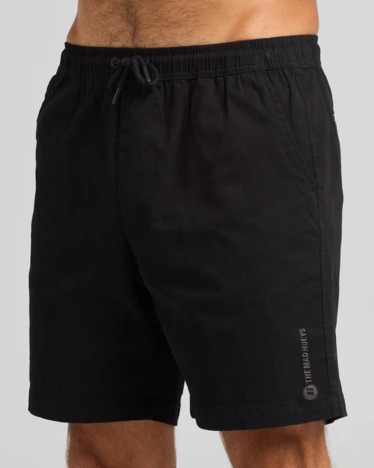 Black shorts with a brand logo on a gray background