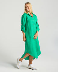 Woman wearing a green dress on a plain background