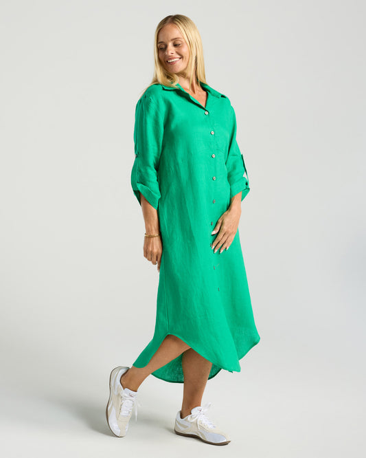 Woman wearing a green dress on a plain background
