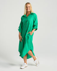 Woman wearing a green dress on a white background