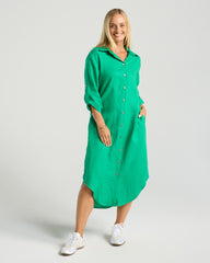 Woman wearing a green dress with a plain background