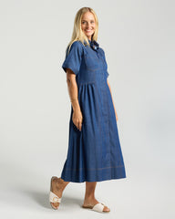 Woman wearing a blue dress on a plain background