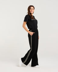 Woman wearing a black outfit with a logo on a white background
