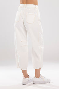 White jeans worn by a person on a white background