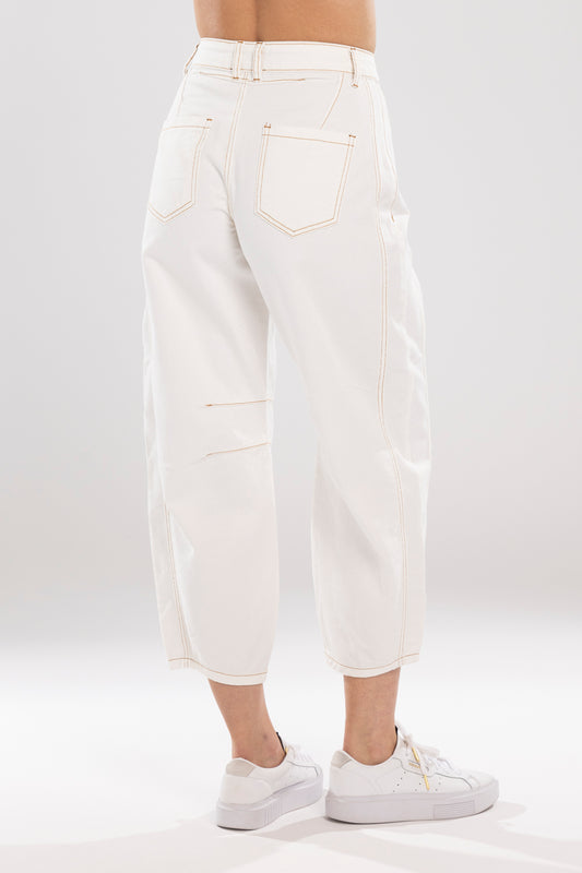 White jeans worn by a person on a white background