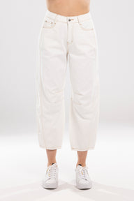 White jeans worn by a person on a white background