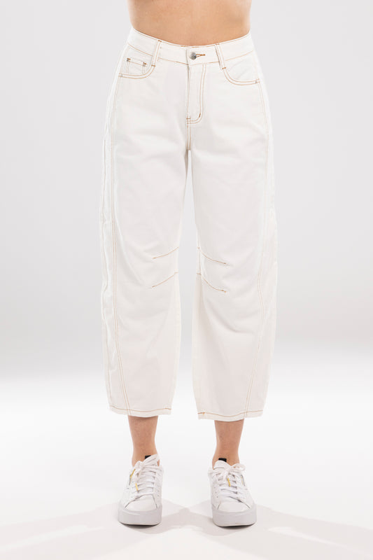 White jeans worn by a person on a white background