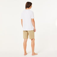 Person wearing a white t-shirt and beige shorts on a white background