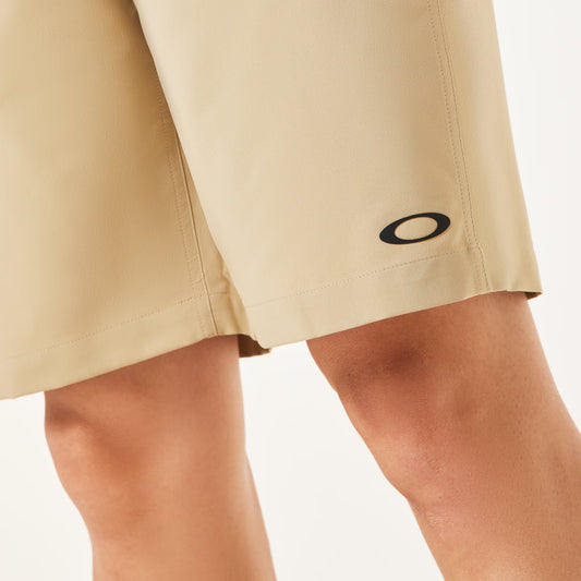 Beige shorts with a brand logo on a white background