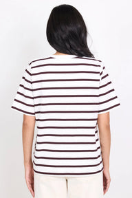 Person wearing a striped shirt with a plain background