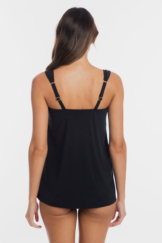 A woman shown from the back wearing a black camisole tank top with adjustable shoulder straps and small gold-tone hardware, against a plain light gray studio background.
