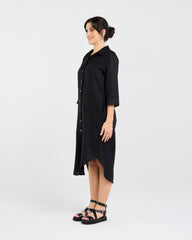 Woman wearing a black dress with a white background