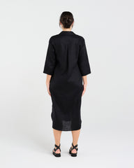 Woman wearing a black dress with a white background