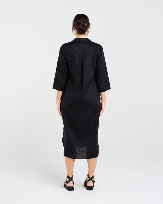 Woman wearing a black dress with a white background