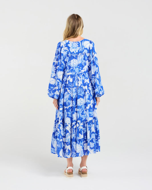 Woman wearing a blue floral dress on a white background