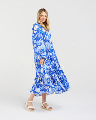 Woman wearing a blue floral dress on a white background