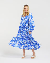 Woman wearing a blue floral dress on a white background