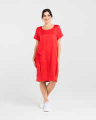 Lady wearing Blackstone Lilian Linen Bubble Hem Dress in Poppy Red with White Background