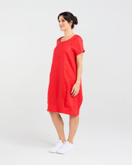 Lady wearing Blackstone Lilian Linen Bubble Hem Dress in Poppy Red with White Background