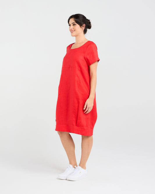 Lady wearing Blackstone Lilian Linen Bubble Hem Dress in Poppy Red with White Background