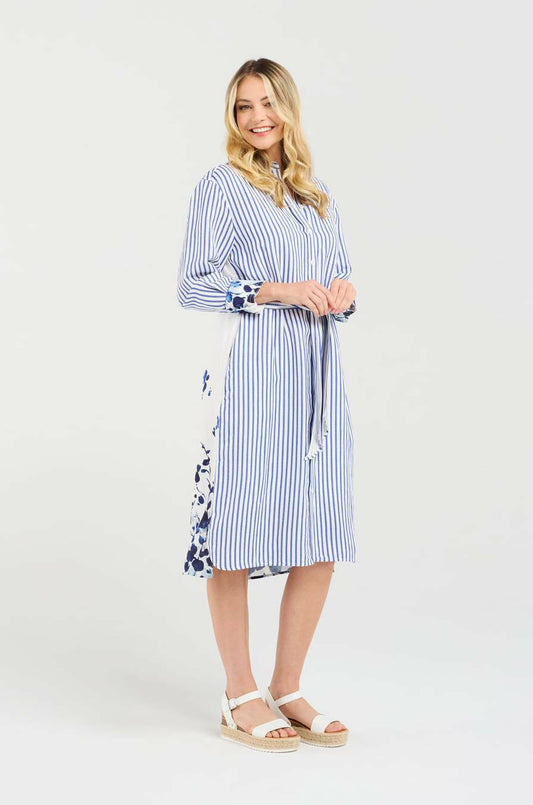 Woman wearing a blue and white striped dress with a floral pattern on a white background