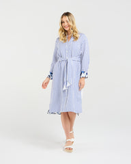 Woman wearing a blue and white striped dress on a white background