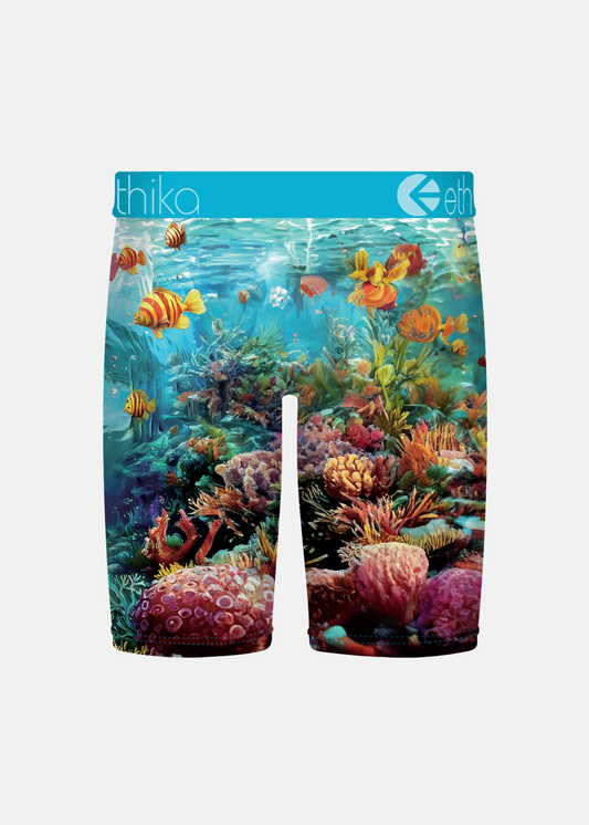 Colorful swim shorts with an underwater scene design on a white background