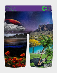 Multicolored shorts with nature-themed design featuring mountains, trees, and a planet.