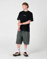 Person wearing a black t-shirt and gray cargo shorts on a white background