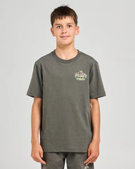 Young boy wearing a gray t-shirt with a logo on a light gray background