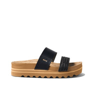 Black sandal with a brown sole on a white background
