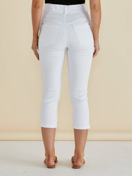 Person wearing white capri pants on a beige background